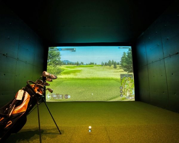 A modern indoor golf simulator with realistic course graphics, located in Mississauga, Canada.